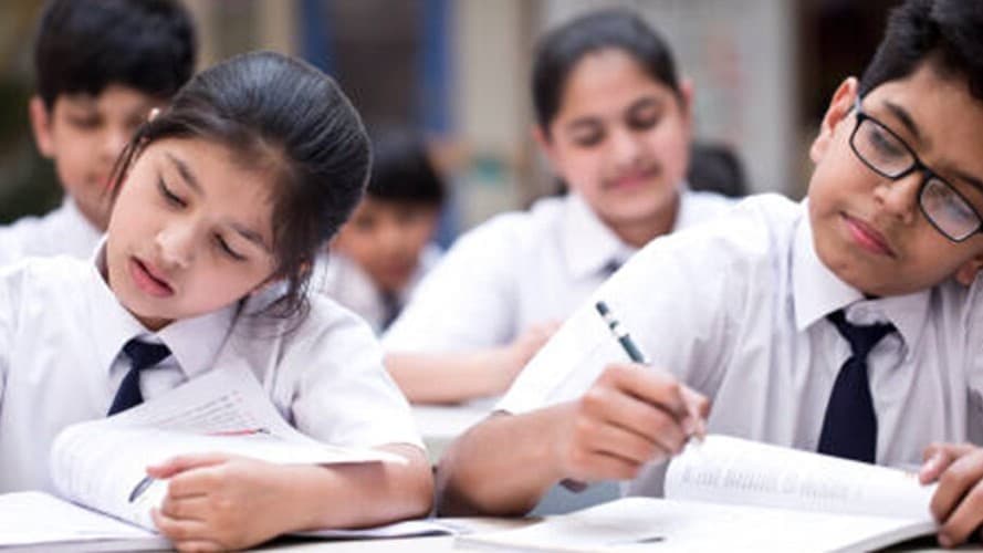 Secondary students studying attentively in class